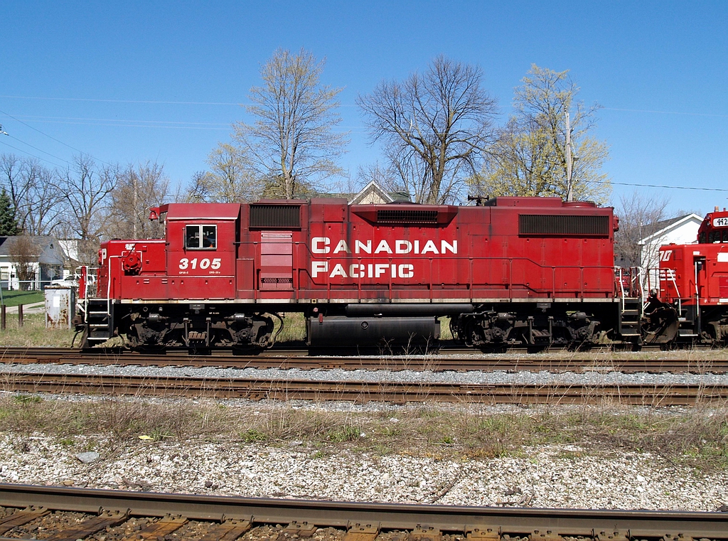 The lead unit on TK22, CP 3105 is heading down the west back track at Galt along with SOO 4420 - CP 3045 towing a string of 25 loaded autoracks of new Toyota\'s. The tail end was onto the Galt Sub @ 12:54.