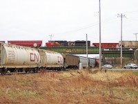 Peterborough Bound CN hoppers meet up with a Mac Yard Bound manifest in Box Grove.