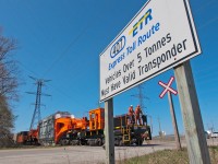 After protecting the crossing at Britannia Rd, the crew of the 8212 (cndr blocked by the sign) is about to board the Schanbel car again for the ride south to protect the final crossing and then onwards to the Hydro One substation. 
