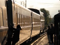 A VIA Rail attendant dismounts to help those waiting to board westbound train 87, as it makes its evening station stop in Brampton.