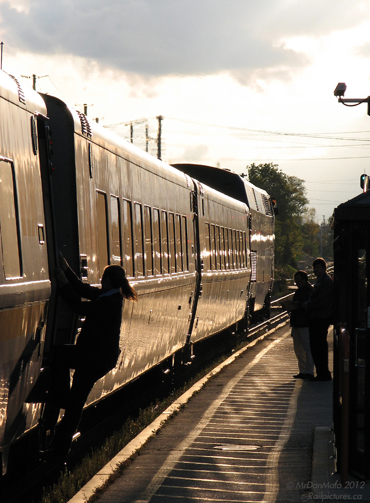 A VIA Rail attendant dismounts to help those waiting to board westbound train 87, as it makes its evening station stop in Brampton.