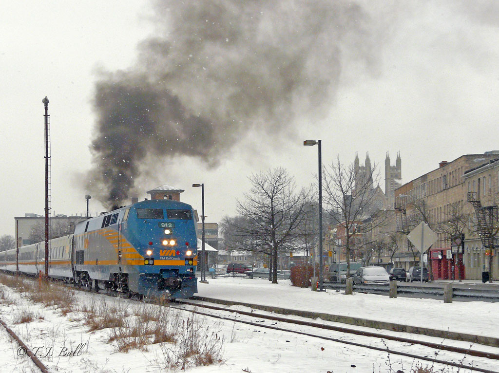 As light snow falls, steam or what passes for it today departs Guelph on VIA 84.