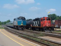 Via Train 72 cruises past CN 580 on the North Track and is about to make its station stop in Brantford.  Via 6443 is in charge of 72 today.