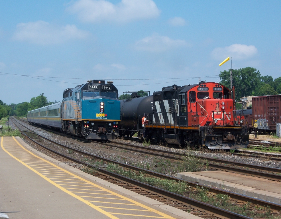 Via Train 72 cruises past CN 580 on the North Track and is about to make its station stop in Brantford.  Via 6443 is in charge of 72 today.
