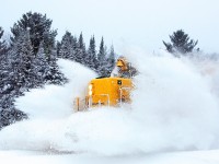 Although the line had been cleared by the passage of 697 some 4 1/2 hours previously the continuing snowfall along with the passing of a road plow made enough of a bank for 1809 to pick up some frosty sideburns as 698 hit the Old Muskoka Road crossing.