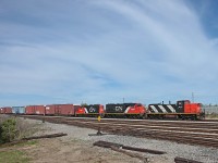Three fine-lookin' GMDs led by GMD1u 1437 push boxcars up the hill from Oakville Yard to the Ford Assembly Plant on a warm and breezy spring day.