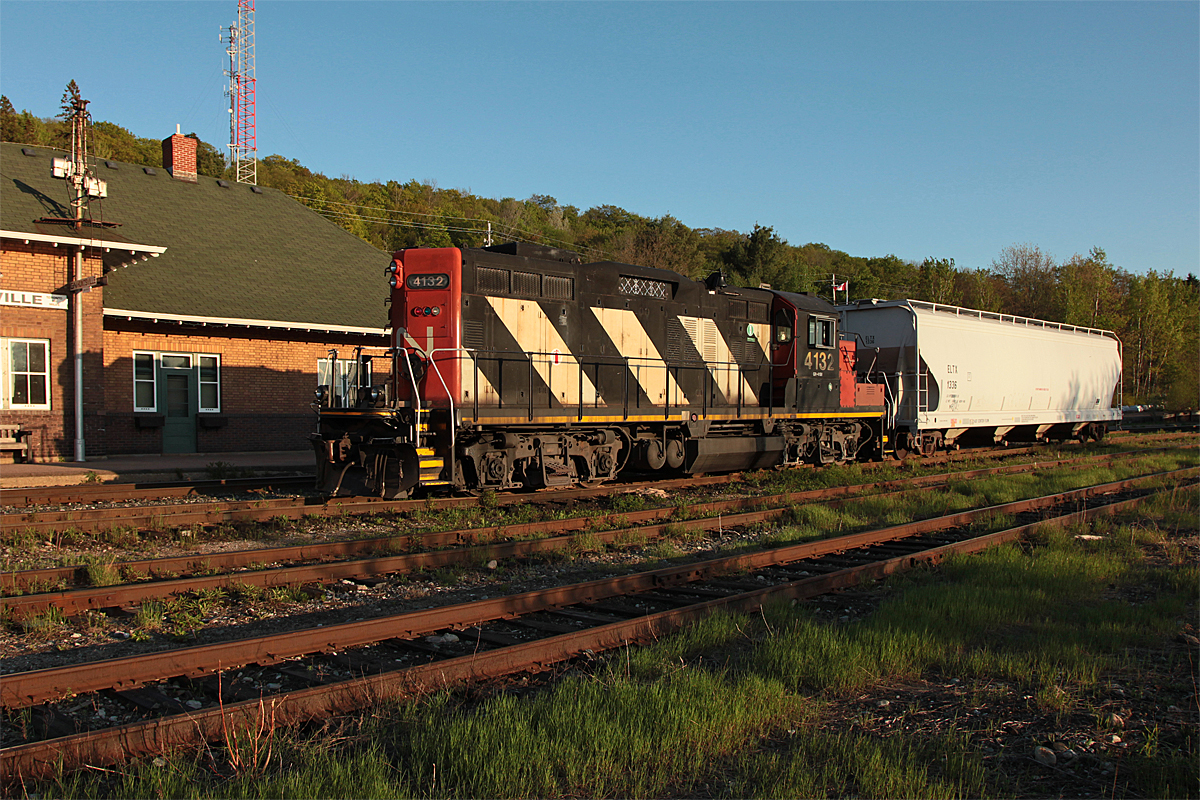 A full view of Huntsville Station at sunset with the local roadswitcher at rest for the night in front.