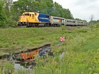 Who needs sunshine when you've got sqeaky-clean 1809 to brighten the scene? The swamp is quickly drying up due to an unusually dry spring but there's still enough standing water to catch a reflection of this shiny beast as it passes the Mile 138 marker on the CN Newmarket Sub.