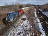 CP 147 with a bluebird leading, flies around the curve at the east end of Lobo. 