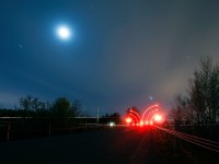 The moon's out, the crossing at Mile 17.15 of the Dundas Sub comes alive as CN 383 blasts through the eastern end of the double crossings with a heavy train for CSX Lang Yard in Toledo, Ohio. 