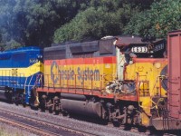 [editors note - image accepted due to rarity of image despite image quality] CSXT 6633 ex Chesapeke and Ohio 6633 is seen in transit on a colourful CN freight.  6633 was damaged in an accident, but I have yet to find out where or when.