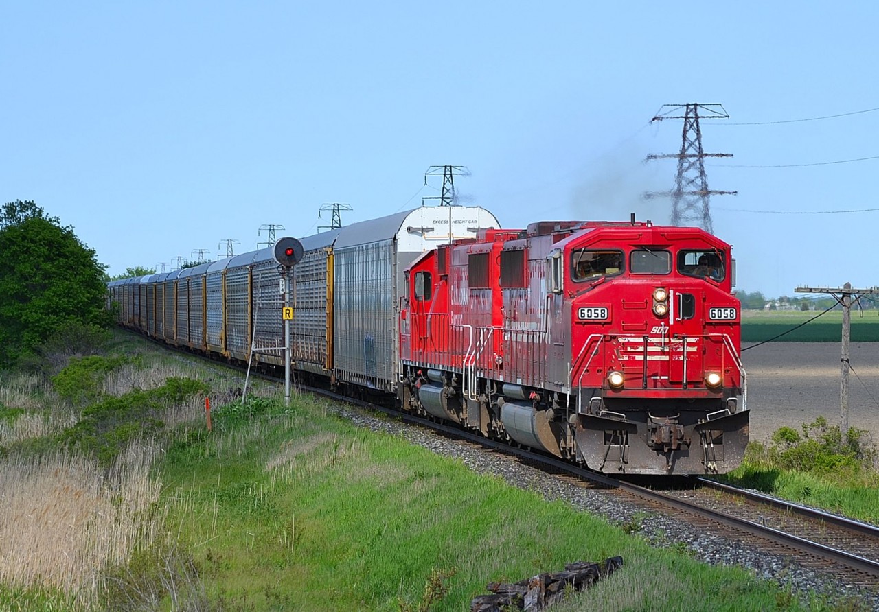 CP 147 led by SOO 6058 and CP 6228 (former SOO 6028), heads westbound into Tilbury as it passes the block signal at mp 77.4