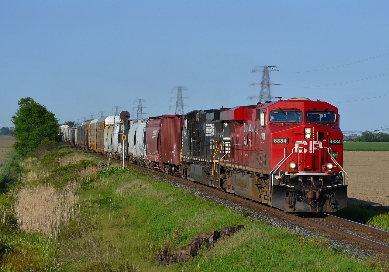 CP 615 led by CP 8884 & NS 9048 hauls this mixed freight/empty crude oil train westbound past the block signal at mp 77.4