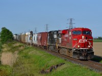 CP 615 led by CP 8884 & NS 9048 hauls this mixed freight/empty crude oil train westbound past the block signal at mp 77.4