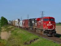 CP 615 led by CP 8884 & NS 9048 hauls this mixed freight/empty crude oil train westbound past the block signal at mp 77.4