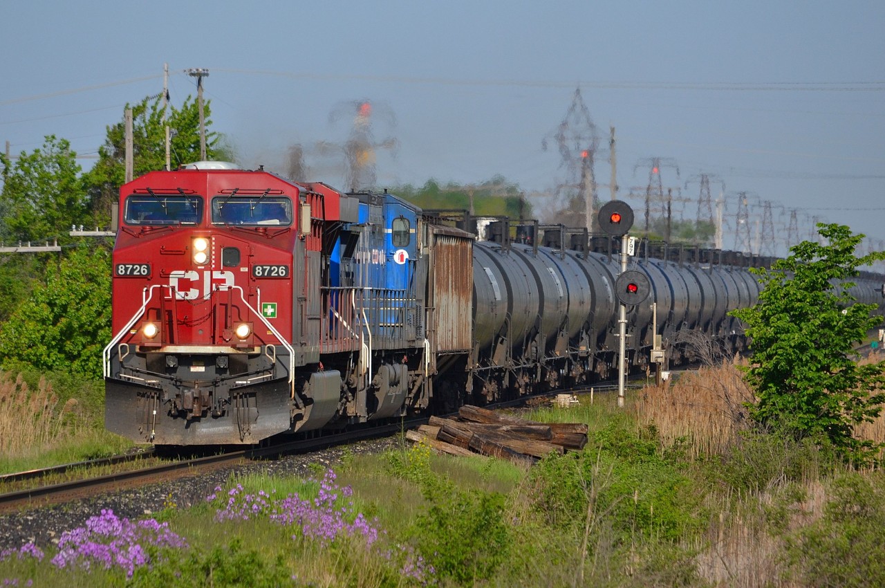 CP 640 an ethanol train with a CP/CEFX lashup, charges eastbound past the east siding switch in Tilbury on a sunny morning.