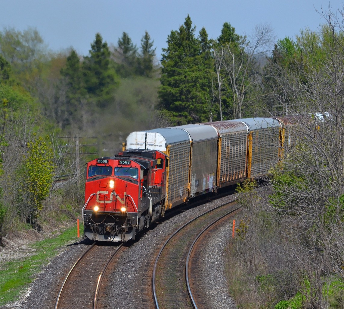 CN 393 led by a pair of Dash 9-44CWs, rounds the bend at the Denfield Bridge on its way towards Sarnia.