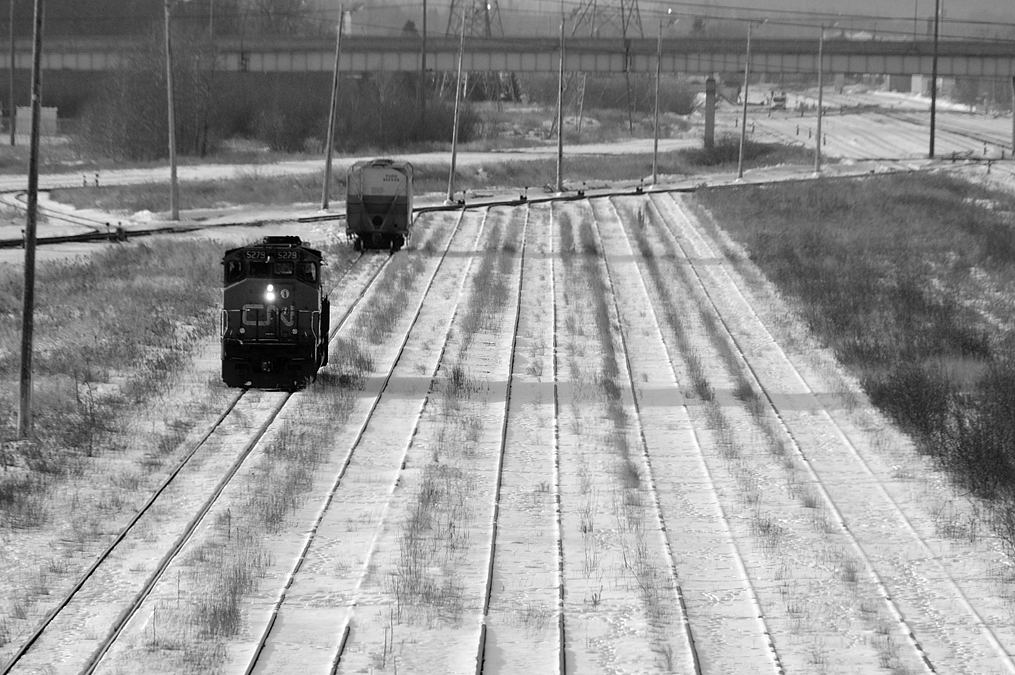 Winter is a lonely time to railroad in Thunder Bay. The crew of the 07:30 Neebing job backs their SD40-2(W) 5305 down through the empty D yard to grab a solitary car switched out from ConAgra Malt by CP in the early overnight hours.