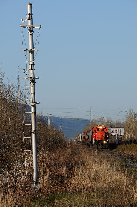 The old signal mast that once stood and protected the diamond between the CN Kashabowie and CP Nipigon Sub sits forlorn and dilapidated. Signal-less, its ladder bent out of shape over the years it once governed eastbound movements on the former south track. Today the former north main is what remains, trains like the one approaching, the daily Fort Frances- Thunder Bay freight A436, led by CN 2109 now governed by a dwarf signal just out of the frame on the right hand side of the picture.