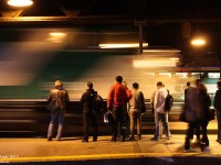 Evening Lakeshore West passengers wait patiently on the platform as F59PH 562 streaks past, pulling into the station on train #927 bound for points west.
