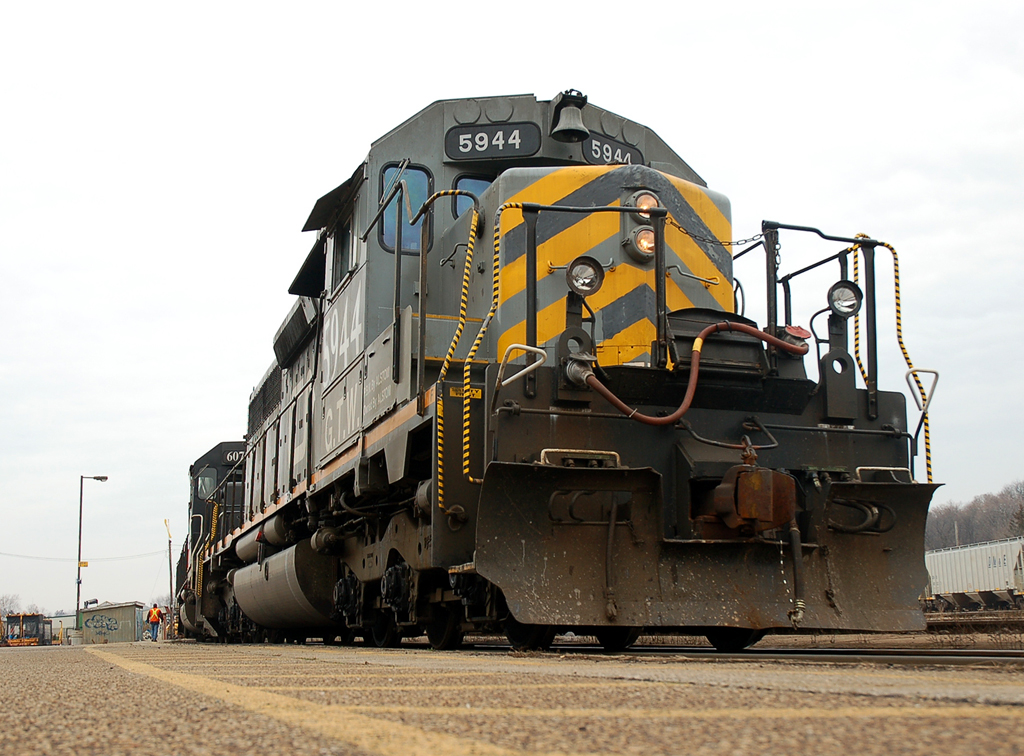 392 stopped on the South track to do work in the yard with a consist of GTW 5944, IC 6072, CN 5611 offers a unique photo angle