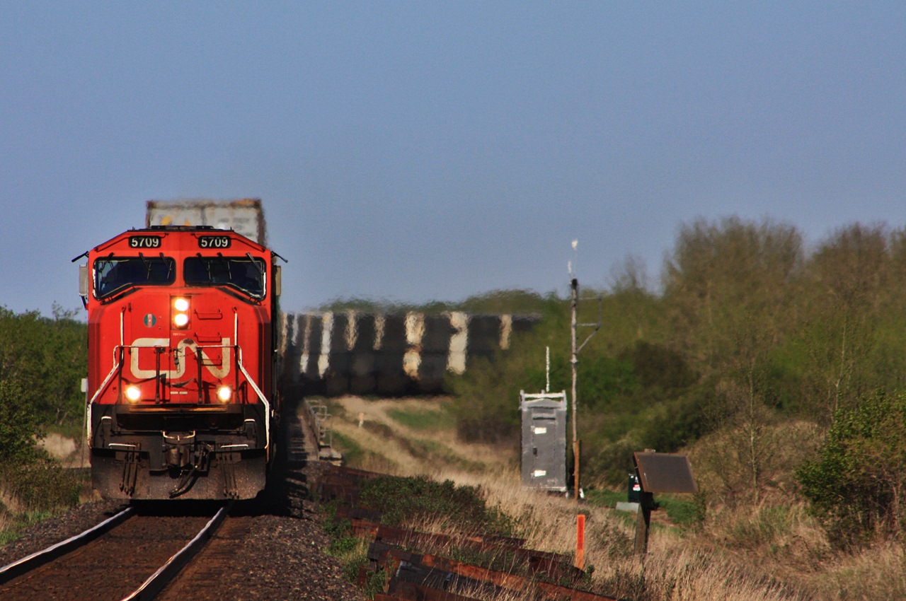 CN 115 with 5709 and IC 1029 round the curve and across the cut arm trestle.