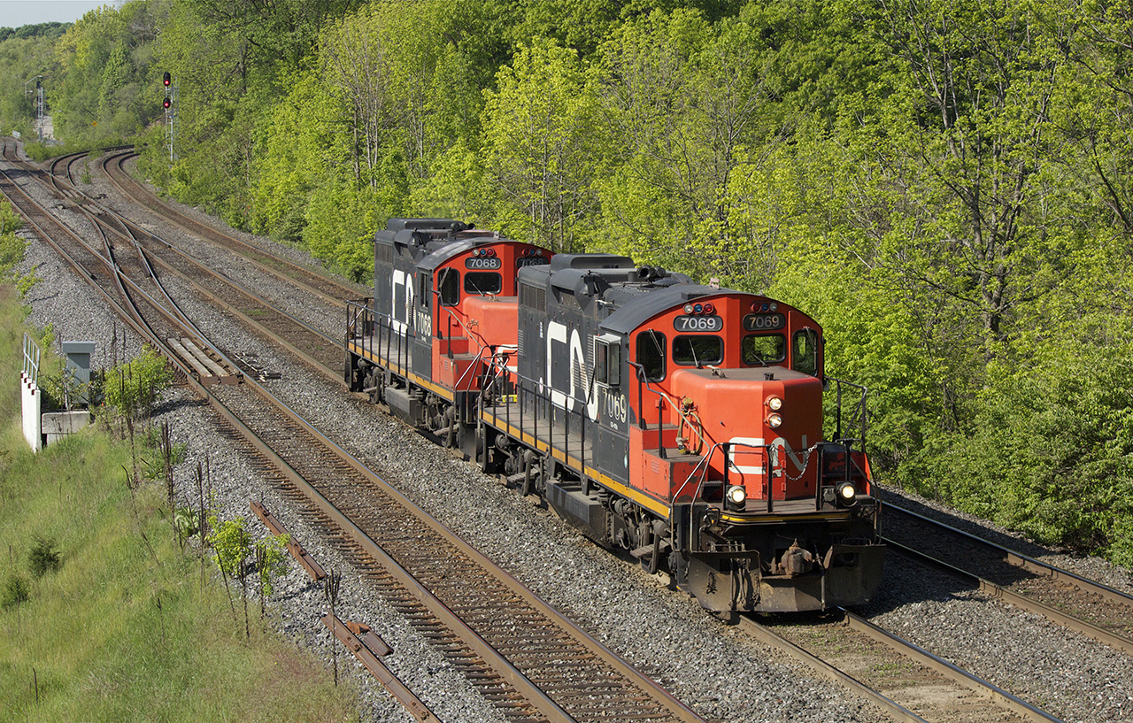 After hauling a D9 dimensional to Hamilton Yard, these two geeps head light back to Oakville.