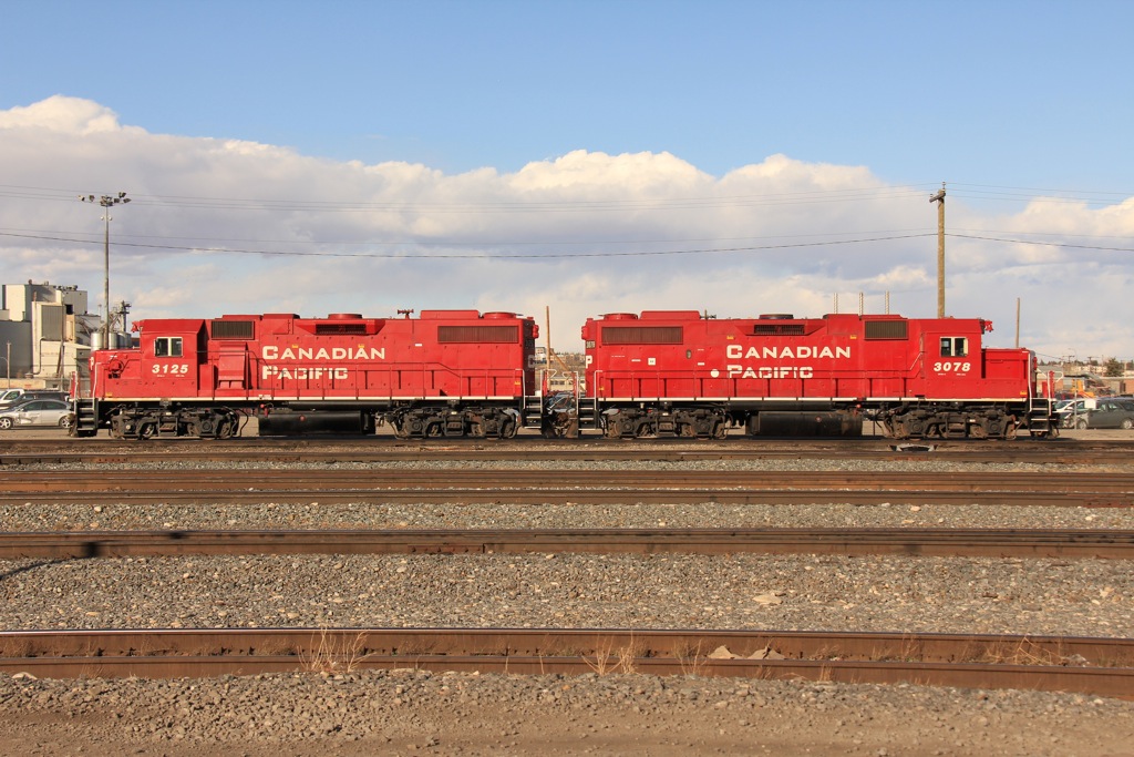 GP38-2s 3125 and 3078 bask in the sun at the north end of Alyth yard.
