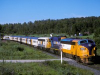 On one of the few sunny days during the summer of '03 the Polar Bear Express is headed northwards. This is about 5 miles north of town.