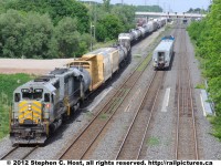 CN 435 has work at Aldershot Yard, with GTW 5951 and GTW 5945 trailing, while VIA 92 slows for a station stop.