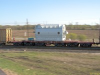 A D5 dimensional load at speed passing through Lovekin siding on CP's Belleville sub. The owner, Kasgro, calls this particular car a "12-AXLE FM" It's a 370 Ton 48' Straight Deck Flat Car, with a load capacity of 744,000 lbs, so this is a pretty serious piece of equipment.