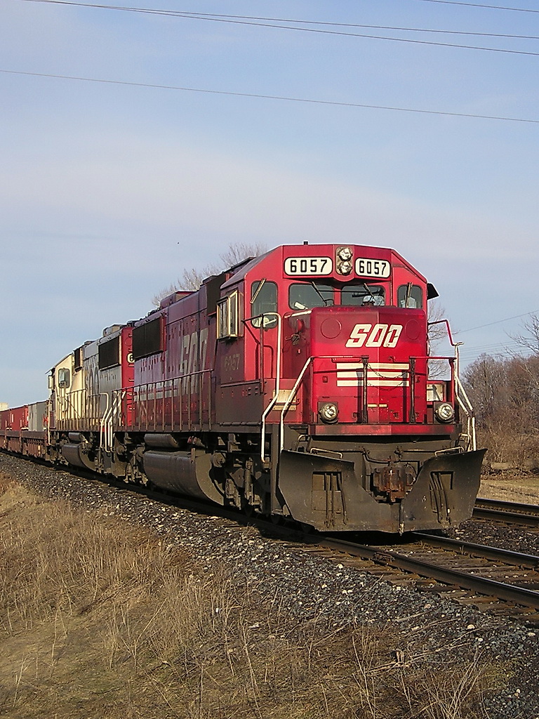 SOO 6057 idles in the Siding, after coming out from downtown London, and having to sit downtown for over 1.5 hours, after hitting a St Patty\'s Partier car, and blocking the entire downtown during Rush hour. The crew was ok to bring the train up to the Lobo Siding after they were given the all clear, but would not take the train to Windsor