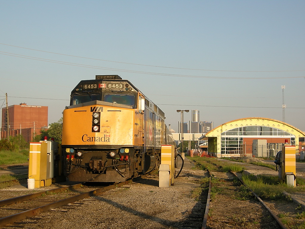 The Last UnRebuilt VIA Rail F40PH-2 Sits in the Morning sun, awaiting its trip to Toronto on VIA Train #72, with the background of Hiarm Walkers Warehouse on the left, Ren Cen in Detroit in the back, and the new VIA Rail station being build on the Right side.