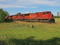 A southbound CP manifest with a "90MAC" in the lead position prepares to take the siding at Craighurst for a meet with northbound priority intermodal traffic.