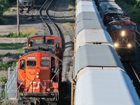 After giving the conductor of CN 399 a ride up to the head end of the train, a pair of old warriors head back to finish up switching duties at Aldershot Yard. CN 383 is also seen on track two running around CN 399 for the Dundas Sub. 