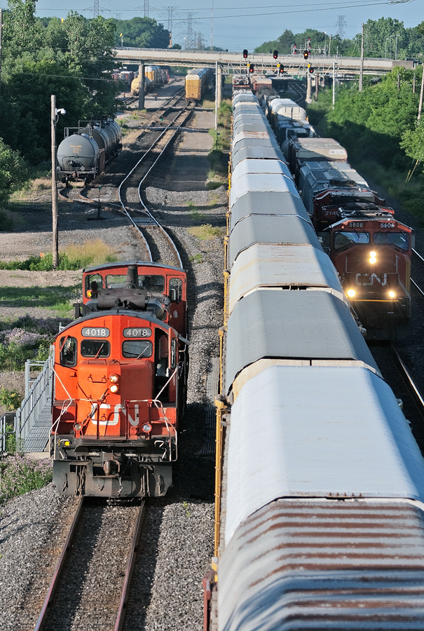 After giving the conductor of CN 399 a ride up to the head end of the train, a pair of old warriors head back to finish up switching duties at Aldershot Yard. CN 383 is also seen on track two running around CN 399 for the Dundas Sub.