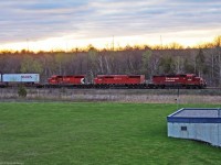 A trio of units with a barn lead an early morning x-pressway train westward to Toronto Yard.