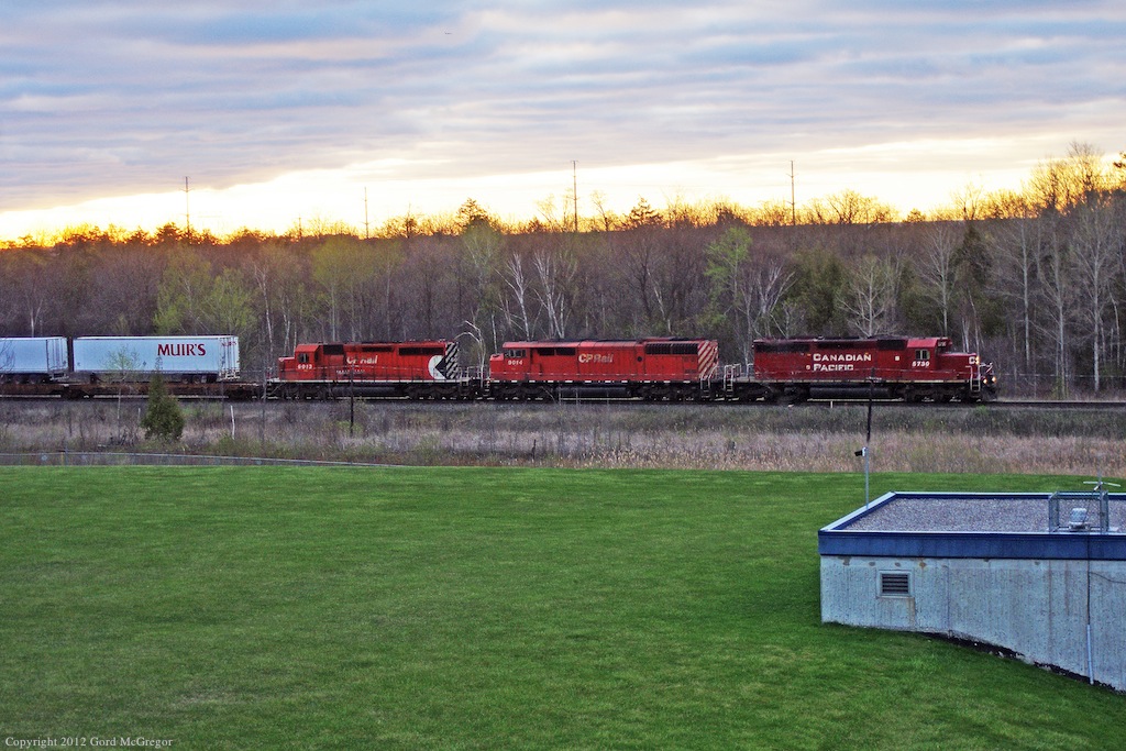 A trio of units with a barn lead an early morning x-pressway train westward to Toronto Yard.