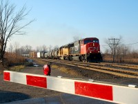 What I believe is CN 390 makes it's way past the crossing at Powerline Road with CN 5711 - UP 3331 and 73 cars