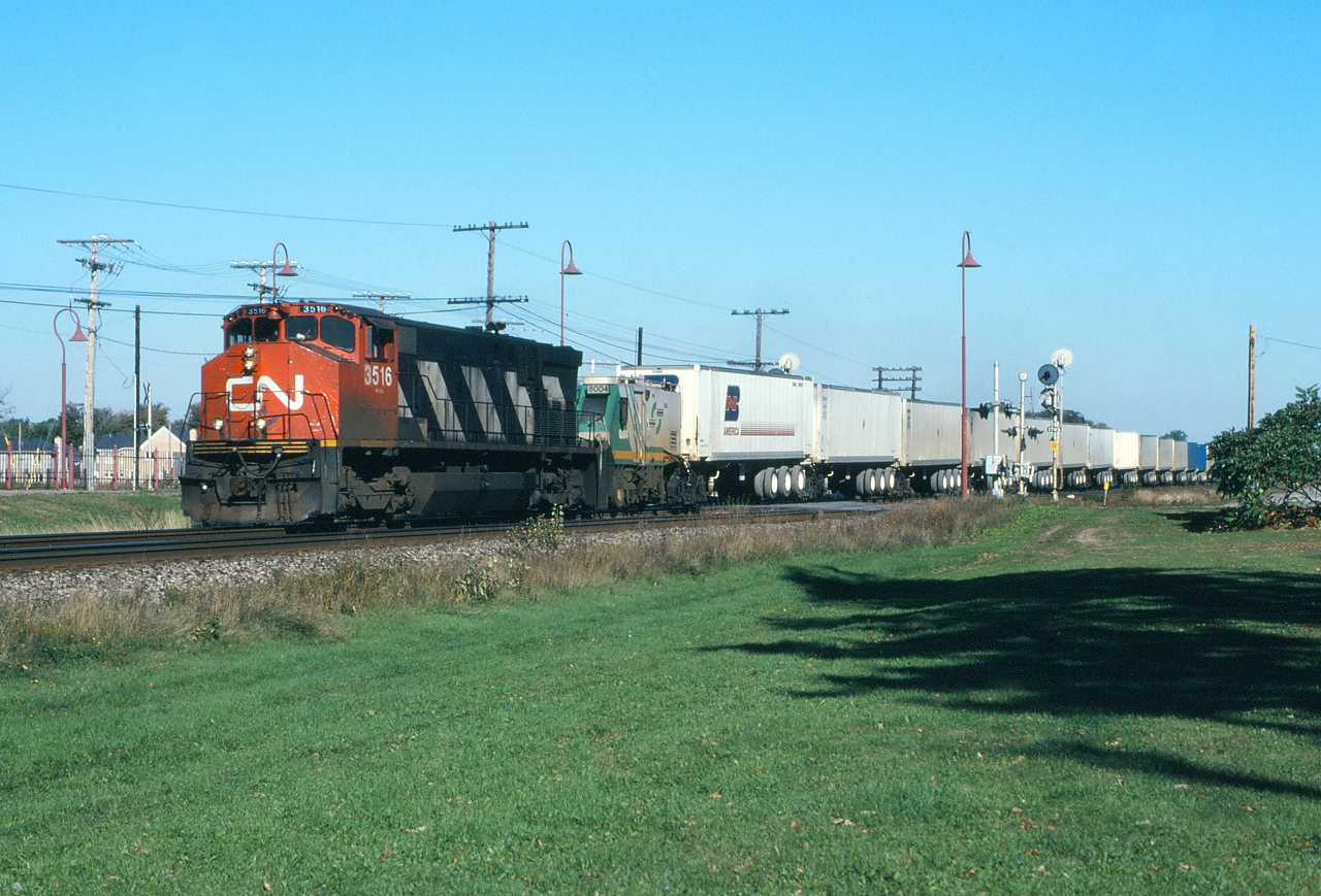 CN 281 rolls through Beaconsfield behind CN 3516 after the Eco Rail unit died.