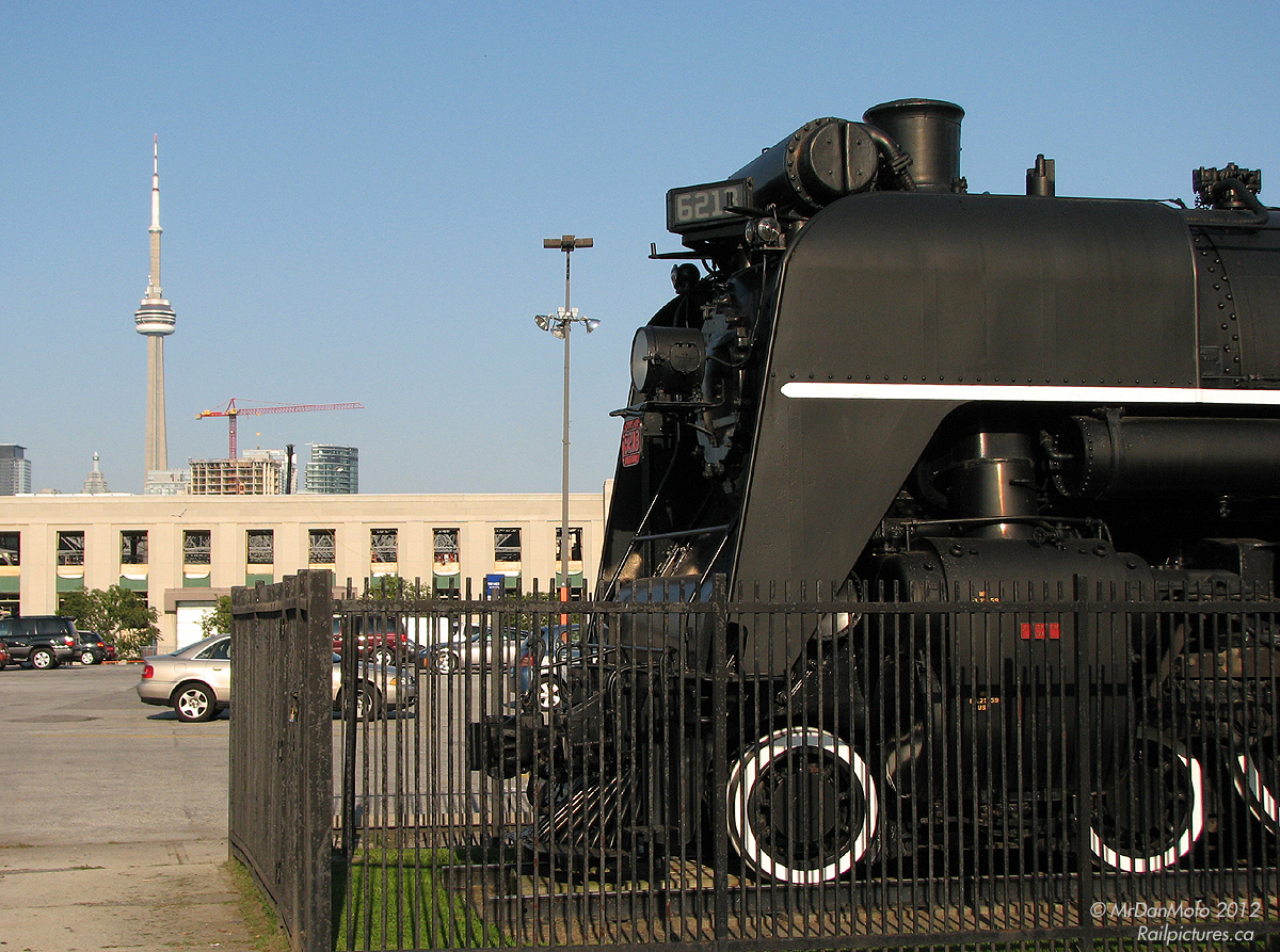 So close and yet so far. For decades, CNR 6213 has sat at the Canadian National Exhibition in Toronto, next to the Stanley Barracks in her own pen. An excursion runner in the 1960's, she was replaced by another Northern type steamer and then donated to the City of Toronto, who put her on display. Unlike other display equipment that often times falls into disrepair, a small preservation group kept 6213 ship-shape, and a year or two after this photo was taken, 6213 was moved to the Toronto Railway Heritage Association's Roundhouse Park by the CN Tower, fitting in better with in its new railway environment than in the middle of a parking lot..