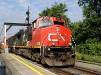 CN-2611 C-44-9W leading containers covoy to Halifax N.S. passing at via rail St-Lambert P.Q.cn rte 120 at 8:38am 