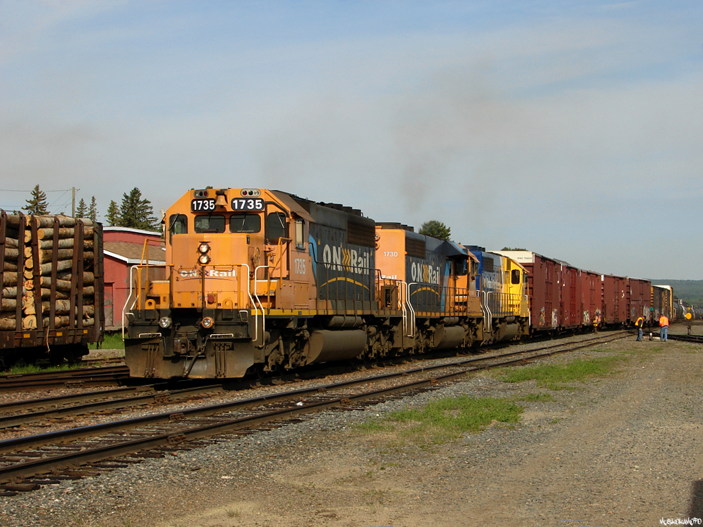 ONT 214-01 - ONT 1735 South pulling out of Englehart yard with 62 cars for North Bay behind SD40-2\'s 1735/1730/1733.