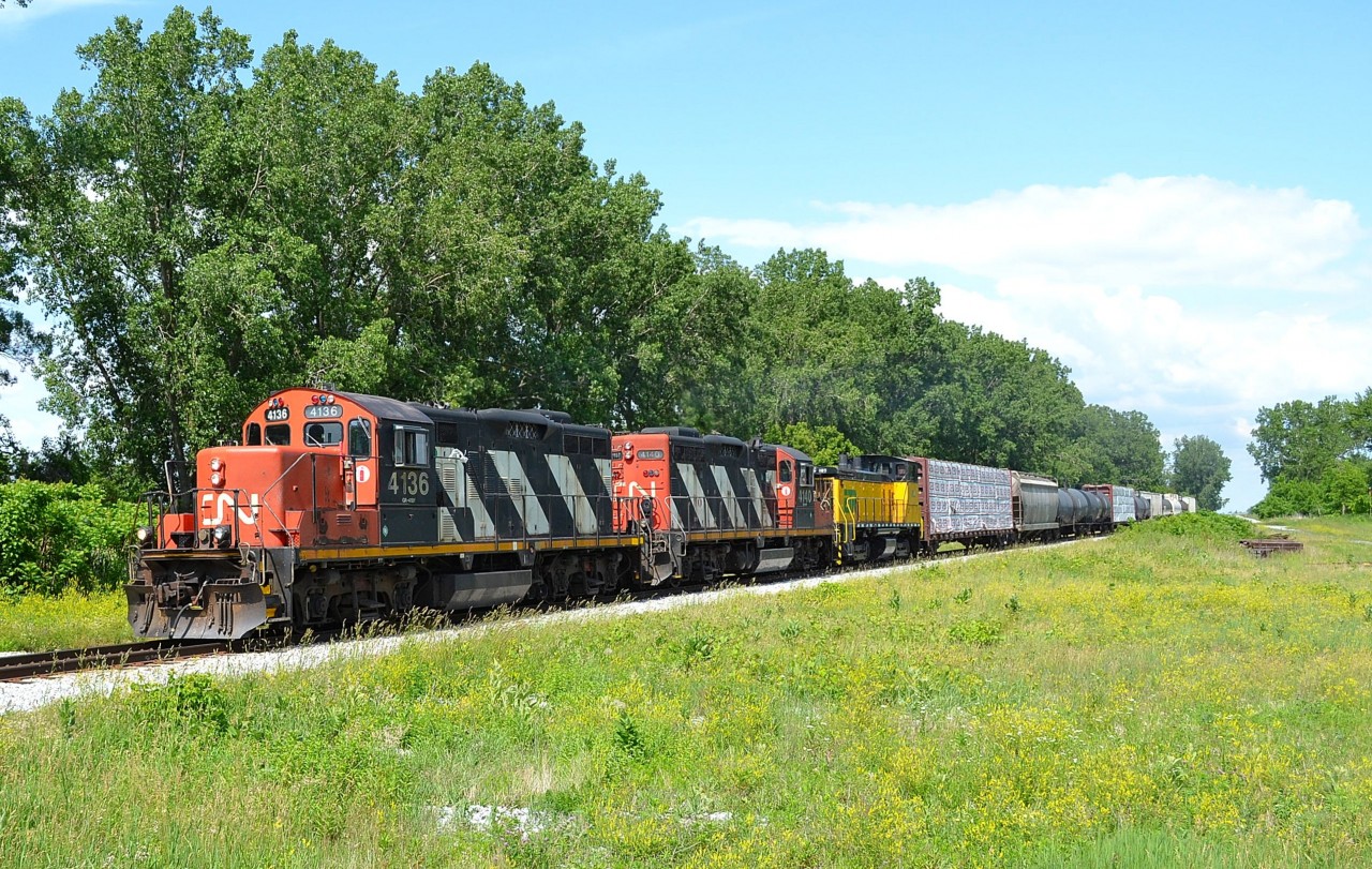 CN 439 heads westbound thru Jeannettes Creek with ETR 107 in the consist after receiving a new engine at the Lambton Diesel shop in Sarnia.