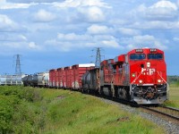 With threatening clouds looming in the background, CP 441 led by brand new 8958 rounds the bend thru Tilbury heading westbound towards Windsor.