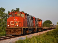 CN 438 led by a pair of GP38-2Ws, passes thru Jeannettes Creek on its way towards London in the 6:30am morning sun.