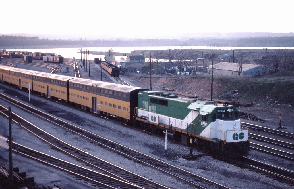 GO 978 departs Hamilton with 9811 on the head end and GP40TC 9804 shoving on the rear; GO was testing C&NW Bi-Levels at the time.