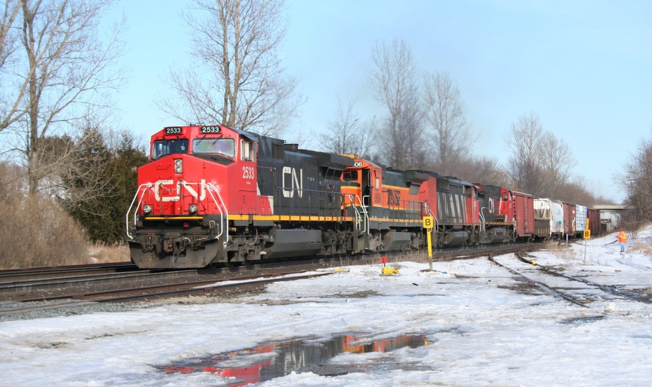 A BNSF B40-8 provides a splash of colour to a CN westbound freight at Copetown, Ontario.