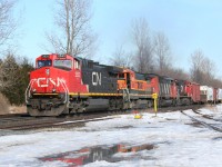 A BNSF B40-8 provides a splash of colour to a CN westbound freight at Copetown, Ontario.