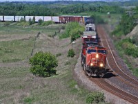CN 312 heads east with 5723 at the helm as they snake through the double track section at Arrow lake Manitoba. They just passed by train 115 and are slowing for a meet with 111 at the east end of the double track.